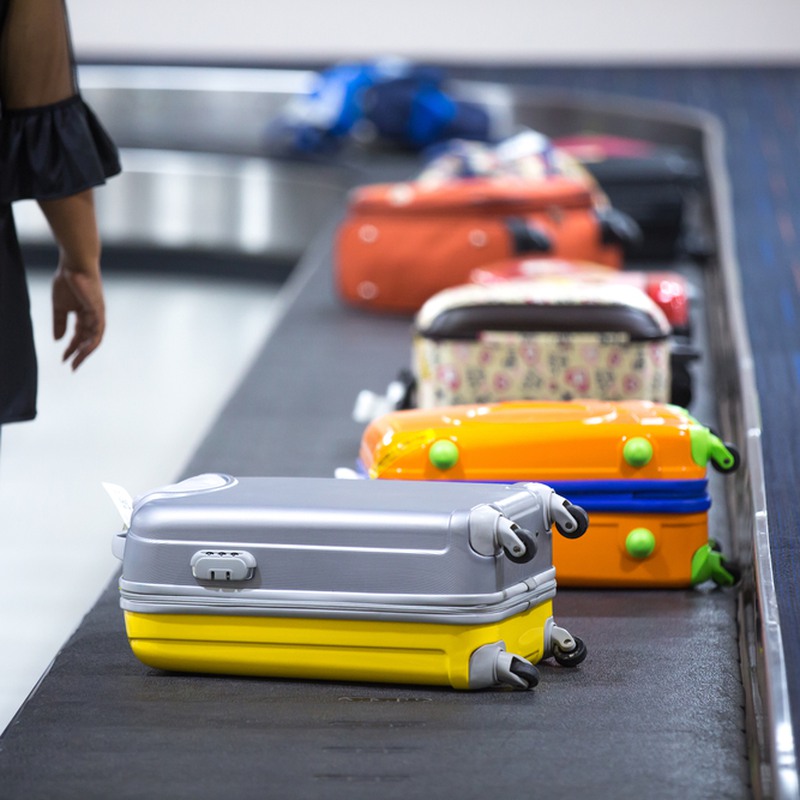 Travel Writing Suitcases on luggage carousel 